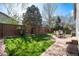 Landscaped backyard featuring a well-maintained lawn, patio set, and privacy fence at 1374 Spotted Owl Way, Highlands Ranch, CO 80129