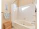 Bathroom featuring a soaking tub, tile surround, and wicker basket at 1374 Spotted Owl Way, Highlands Ranch, CO 80129