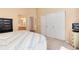 Bright bedroom featuring plush carpet, closet doors, and bathroom access at 1374 Spotted Owl Way, Highlands Ranch, CO 80129
