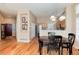 Open dining area featuring hardwood floors and view into the kitchen at 1374 Spotted Owl Way, Highlands Ranch, CO 80129