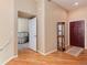 Open entryway showcasing hardwood floors and access to the bedroom at 1374 Spotted Owl Way, Highlands Ranch, CO 80129