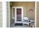 Welcoming front porch with comfortable seating, enhancing the curb appeal of the home at 1374 Spotted Owl Way, Highlands Ranch, CO 80129