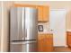 Modern kitchen featuring a stainless steel refrigerator and wooden cabinets at 1374 Spotted Owl Way, Highlands Ranch, CO 80129