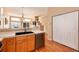 Modern kitchen featuring wood floors, stainless steel appliances, and a double basin sink at 1374 Spotted Owl Way, Highlands Ranch, CO 80129