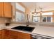 Bright kitchen features white countertops, a double basin sink, and stainless steel appliances at 1374 Spotted Owl Way, Highlands Ranch, CO 80129