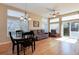 Cozy living room with hardwood floors, large windows, and a sliding glass door at 1374 Spotted Owl Way, Highlands Ranch, CO 80129