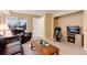 Relaxing living room area with entertainment center and leather furniture at 1374 Spotted Owl Way, Highlands Ranch, CO 80129