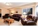 Cozy living room with plush seating, wood coffee table and natural light at 1374 Spotted Owl Way, Highlands Ranch, CO 80129