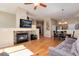 Open-concept living area with a fireplace, hardwood floors, and a view of the dining area and kitchen at 1374 Spotted Owl Way, Highlands Ranch, CO 80129