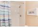 Bathroom shower featuring shower curtain and white tiled walls at 1374 Spotted Owl Way, Highlands Ranch, CO 80129