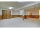 Finished basement area with wood-paneling and carpet at 13901 E Oxford Pl, Aurora, CO 80014