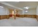 Finished basement area featuring wood-paneling, carpet, and recessed lighting at 13901 E Oxford Pl, Aurora, CO 80014