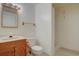 Bathroom featuring a single sink vanity, toilet, and shower at 13901 E Oxford Pl, Aurora, CO 80014