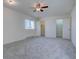 Spacious bedroom with two closets, neutral carpet, and a large window at 13901 E Oxford Pl, Aurora, CO 80014