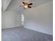 Carpeted bedroom with a fan, closet and exterior door at 13901 E Oxford Pl, Aurora, CO 80014