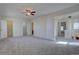 Large bedroom featuring plush carpet, a ceiling fan, and two closets at 13901 E Oxford Pl, Aurora, CO 80014