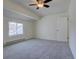 Bright carpeted bedroom featuring a fan, closet and exterior window at 13901 E Oxford Pl, Aurora, CO 80014