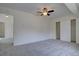 Neutral bedroom showcasing carpeted floors, fan, and closet at 13901 E Oxford Pl, Aurora, CO 80014