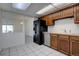 An open kitchen offers ample counter space, stainless steel appliances, and tile flooring at 13901 E Oxford Pl, Aurora, CO 80014