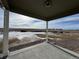 View from covered patio shows open space and distant homes at 42974 Colonial Trl, Elizabeth, CO 80107