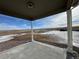 View from covered patio shows open space and distant homes at 42974 Colonial Trl, Elizabeth, CO 80107