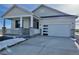 House exterior featuring a modern design, stone accents, and a two-car garage at 42974 Colonial Trl, Elizabeth, CO 80107