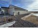 House exterior with landscaping and a gravel driveway at 42974 Colonial Trl, Elizabeth, CO 80107