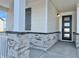 Inviting front entrance with stone pillars and a modern front door at 42974 Colonial Trl, Elizabeth, CO 80107