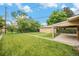 Spacious backyard with lush lawn, mature trees, and detached garage at 260 Flint Way, Broomfield, CO 80020