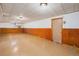 Finished basement with paneled walls, tile ceiling, and lighting at 260 Flint Way, Broomfield, CO 80020