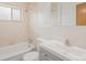 Bathroom features a shower and tub combination, a white vanity and tiled walls at 260 Flint Way, Broomfield, CO 80020