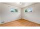 Cozy bedroom features hardwood floors and bright natural light from the windows at 260 Flint Way, Broomfield, CO 80020