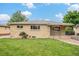 Attractive brick home with a green lawn, flower bushes, and a tidy front yard at 260 Flint Way, Broomfield, CO 80020
