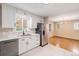 Bright kitchen with stainless steel appliances, white cabinets, and ample counter space at 260 Flint Way, Broomfield, CO 80020