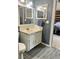 Bathroom with gray tiled floor, blue walls, and white vanity at 6585 W 84Th Way # 109, Arvada, CO 80003