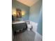 Charming powder room featuring wainscoting, a decorative mirror, and a sink at 6585 W 84Th Way # 109, Arvada, CO 80003