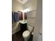 The bathroom features a toilet, vanity with shelves, towels and lights at 6585 W 84Th Way # 109, Arvada, CO 80003