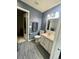 This renovated bathroom features gray tile, a new vanity, and modern fixtures at 6585 W 84Th Way # 109, Arvada, CO 80003