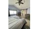 The main bedroom features a sliding barn door to the bathroom and a ceiling fan at 6585 W 84Th Way # 109, Arvada, CO 80003