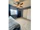 Comfortable bedroom has blue curtains, ceiling fan and good closet space at 6585 W 84Th Way # 109, Arvada, CO 80003