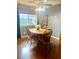 Dining room with hardwood floors, ceiling fan, rustic table and chairs near bright window at 6585 W 84Th Way # 109, Arvada, CO 80003