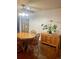 Close-up of a dining room showcasing a wooden table, chairs, and a stylish cabinet at 6585 W 84Th Way # 109, Arvada, CO 80003