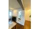 Hallway featuring a display cabinet, hardwood floors, leading to the front door and fireplace at 6585 W 84Th Way # 109, Arvada, CO 80003