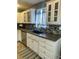 Well-lit kitchen with stainless steel appliances, mosaic backsplash, and white cabinetry at 6585 W 84Th Way # 109, Arvada, CO 80003