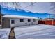 Large backyard with snow-covered ground and a storage shed at 3311 S Logan St, Englewood, CO 80113