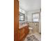 Clean bathroom with wood cabinets and tiled floor at 3311 S Logan St, Englewood, CO 80113