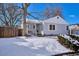 Charming ranch home with a snow-covered front yard and a welcoming porch at 3311 S Logan St, Englewood, CO 80113