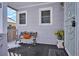 Cozy front porch with a bench and potted sunflowers, creating a welcoming entrance at 3311 S Logan St, Englewood, CO 80113