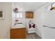 Small kitchen with wood cabinets and white appliances at 3311 S Logan St, Englewood, CO 80113