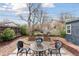 Cozy backyard with patio area, stone pavers, and raised garden beds at 3740 W 54Th Ave, Denver, CO 80221